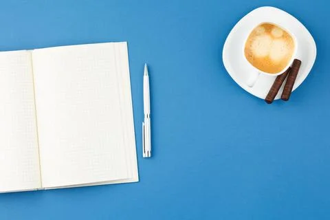 Open notepad with pen and cup of coffee. Stock Photos