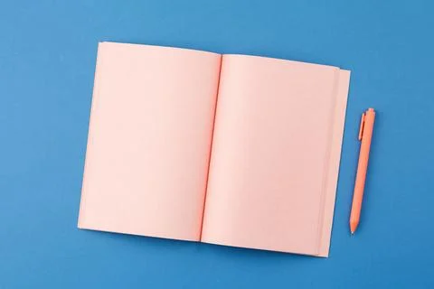 Open notepad with pen on blue background Stock Photos