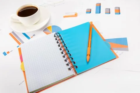 Open notepad with a pen, cup of coffee and documents Stock Photos