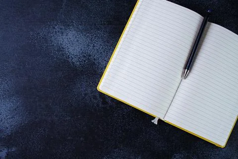 Open notepad with pen Stock Photos