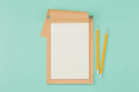 Open notepad with pencil on cyan background. Stock Photos