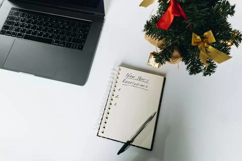 Open notepad with resolutions for new 2024 year text. Near laptop and chris.. Stock-Fotos