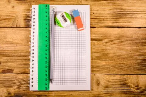 Open notepad, ruler and pencil on a wooden table. Top view Stock Photos