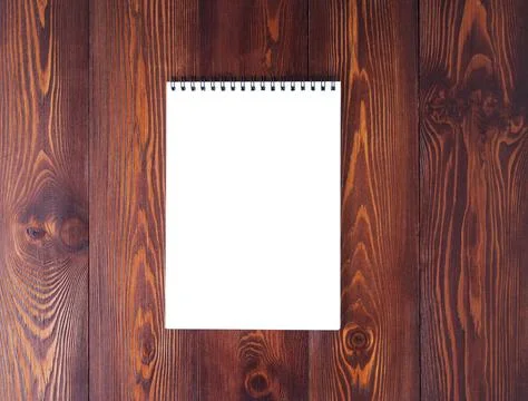 The open notepad with spiral on dark brown wooden table, top view Stock Photos