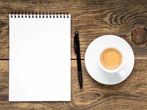 Open notepad with spiral, pen and coffee cup Stock Photos