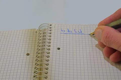 Open notepad with text - to do list. Fountain pen, spiral notebook on table Fotos de archivo
