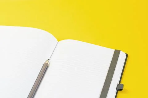 Open notepad on trendy yellow background Stock Photos