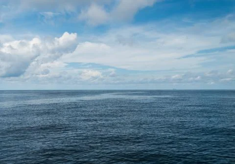 Open ocean and cloudy sky Stock Photos