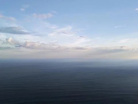 Open ocean view at sunset with clouds across the sky Stock Photos