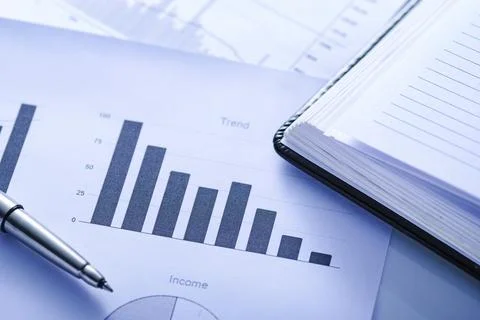 Open office journal on a bar graph with pen Stock Photos