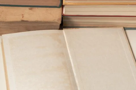 Open old Book blank in front of book stack Stock Photos