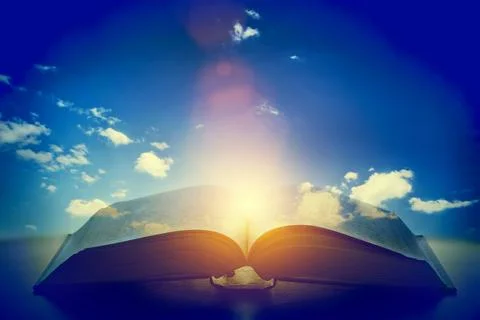 Open old book, light from the sky, heaven. Education, religion concept Fotos Stock