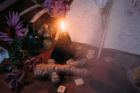 Open old book with magic spells, runes, black candle Foto stock
