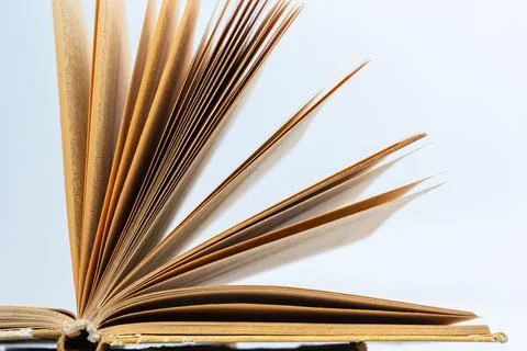 Open old book with text on white background. The concept of reading literatur Stock Photos
