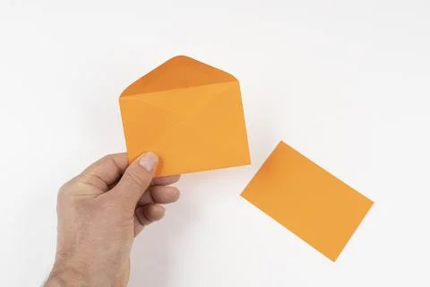 An open orange envelope in the hands Foto stock