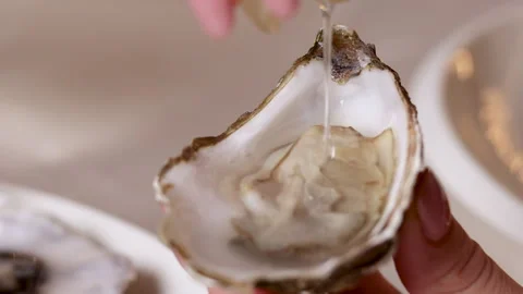 Open oysters on plate with slice of lemon on ice cubes. Stock Footage 274124419