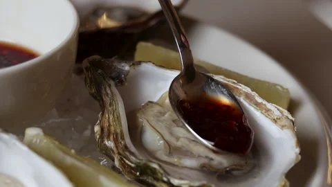 Open oysters on plate with slice of lemon on ice cubes. Stock Footage 274124423