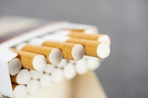 Open pack of cigarettes with several stretched cigarettes close-up Stock Photos