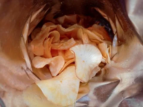 Open package with fresh casava chips. Top view, flat lay Stock Photos
