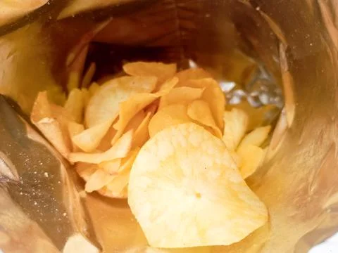 Open package with fresh casava chips. Top view, flat lay Stock Photos