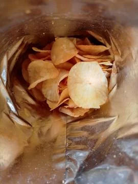Open package with fresh casava chips. Top view, flat lay Stock Photos