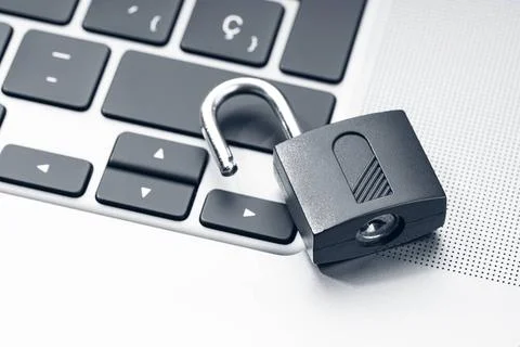 Open padlock on modern laptop. Computer Security Vulnerability concept Ope... Stock Photos