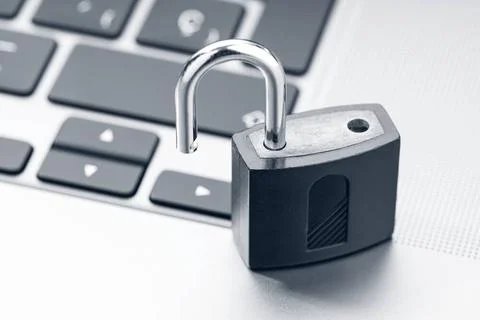 Open padlock on modern laptop. Computer Security Vulnerability concept Ope... Stock Photos
