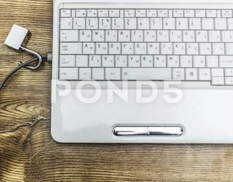 Open padlock on network cables on a laptop. Stock Photos