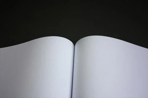 Open page on a black background. Abstract background Stock Photos