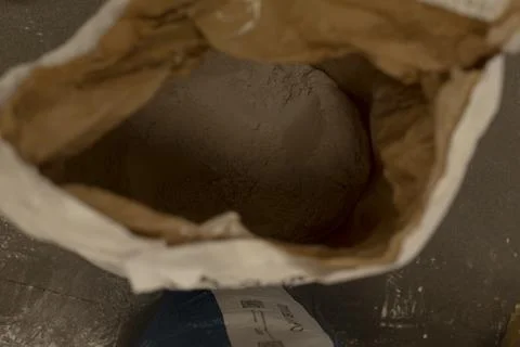 Open paper bag of white baking flour viewed from above with scooped surface Stock Photos