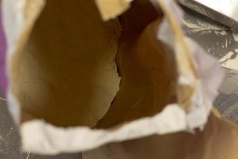Open paper bag with white baking flour viewed from above on wooden kitchen flour Stock Photos