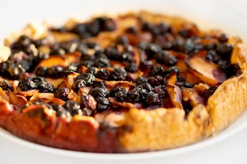 Open pie stuffed with apples and blueberries. Stock Photos