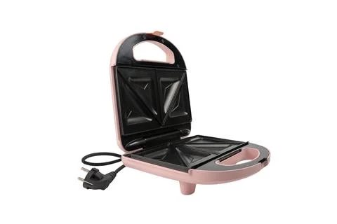 Open pink sandwich maker at a side angle with cord on white Фото