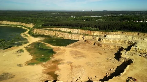 Open-Pit Dolomite Quarry with Lake, Beach, and Forest Background The video shows Stock Footage 277357621