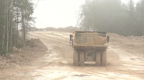 Open-pit dump truck rides away on the road Stock Footage 52816969
