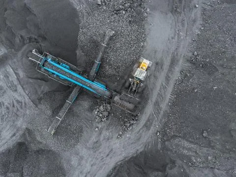 Open pit mine, breed sorting. Mining coal. Bulldozer sorts coal. Extractive Fotos Stock