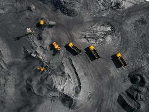 Open pit mine, coal loading in trucks, transportation and logistics, top view Stock Photos