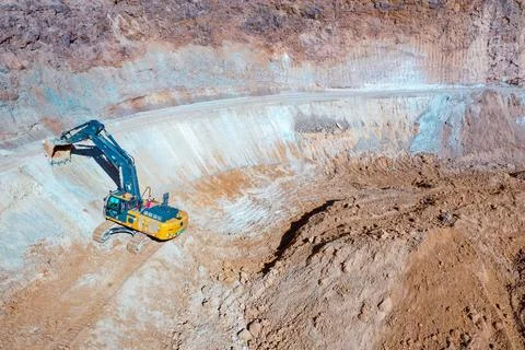 Open pit mine in full operation, with machinery extracting minerals Stock Photos