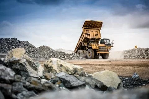 Open pit mine industry, big yellow mining truck for coal anthracite. Stock Photos