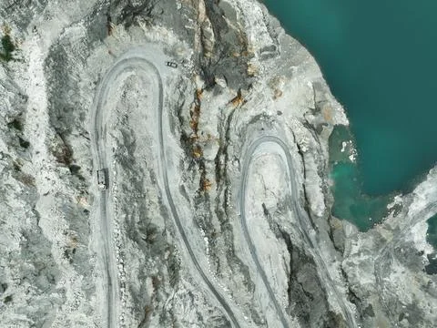 Open pit mine industry. Limestone quarry with backhoe and truck in operatio.. 库存照片