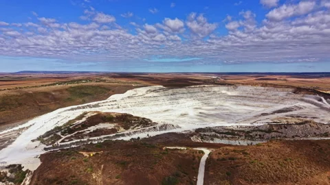Open pit mine landscape showing mining activity in a rural area during daylight Stock Footage 345454960