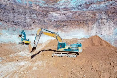 Open pit mine with machinery extracting minerals Stock Photos