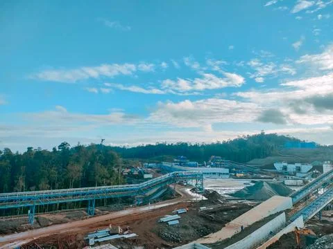 Open Pit Mining Area with Conveyor Systems Under Blue Sky Stock Photos