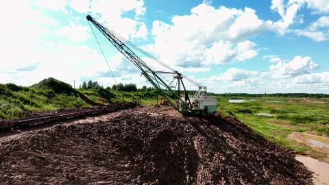 Open-pit mining. Dragline excavator load clay in freight train. 動画素材 203873448