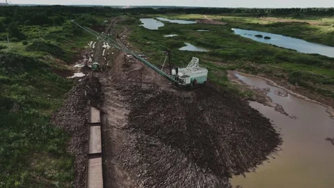 Open-pit mining. Dragline excavator load clay in freight train. Stock Footage 204042708