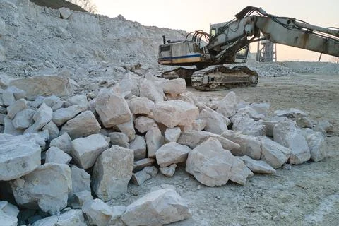 Open pit mining site of construction sand stone materials with excavator Stock Photos
