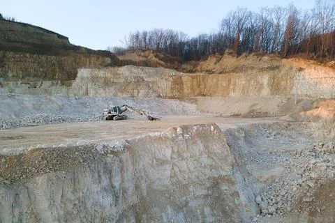 Open pit mining site of construction sand stone materials with excavator Stock Photos
