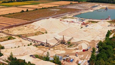 Open pit sand quarry with industrial conveyors and trucks. Sand mining facility Stock Footage 346007443