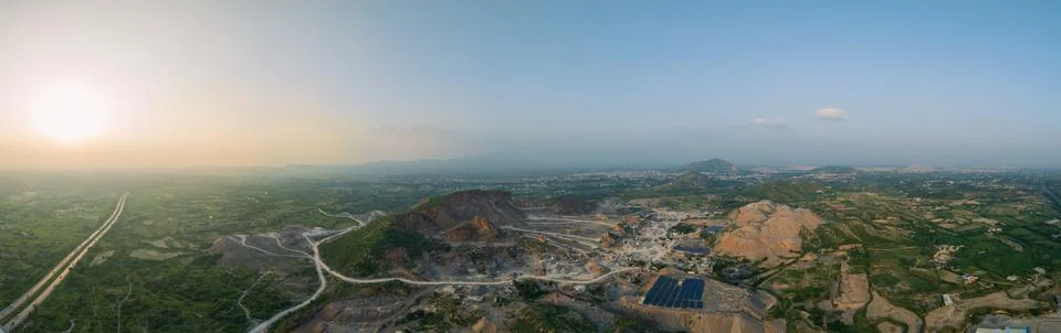 An open pit stone mining quarry at sunset Stock Photos