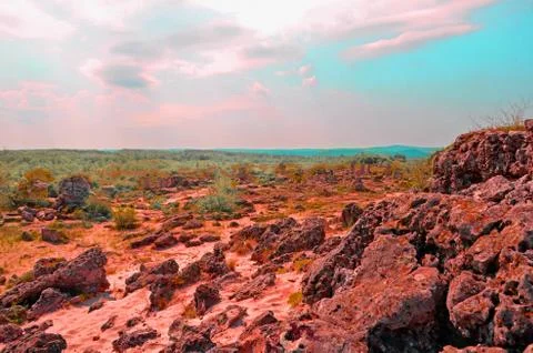 An open plain with a small mountain in the distance, covered with stones and  Stock Photos